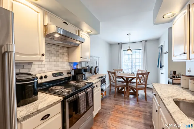 a kitchen with a stove and a wooden floors