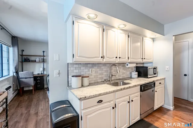a kitchen with a stove a sink and a refrigerator