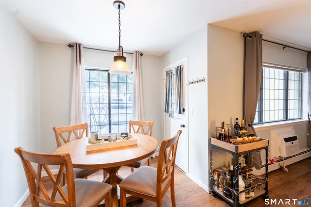 a dining room with furniture and window