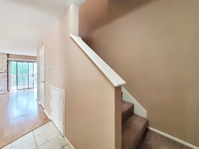 a view of a hallway with wooden floor and entryway
