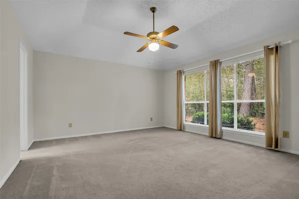 a view of a livingroom with a ceiling fan and window