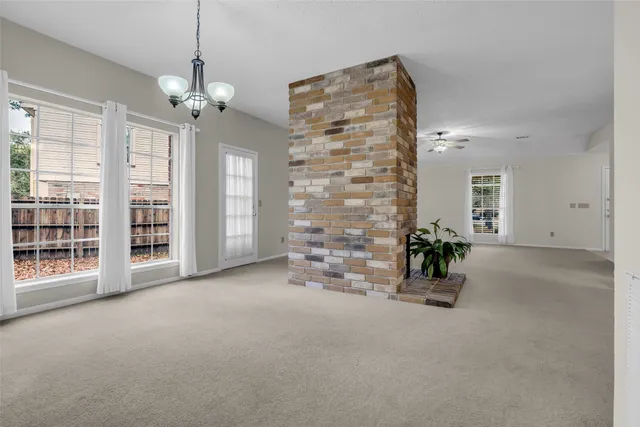 an empty room with windows and cabinet