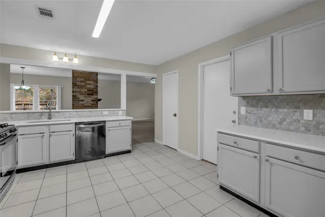 a kitchen with a sink stove and cabinets