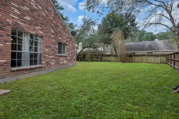a view of a backyard with a garden and entertaining space