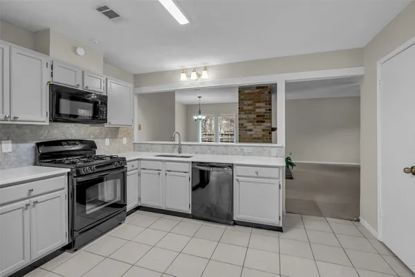 a kitchen with a sink cabinets and stainless steel appliances