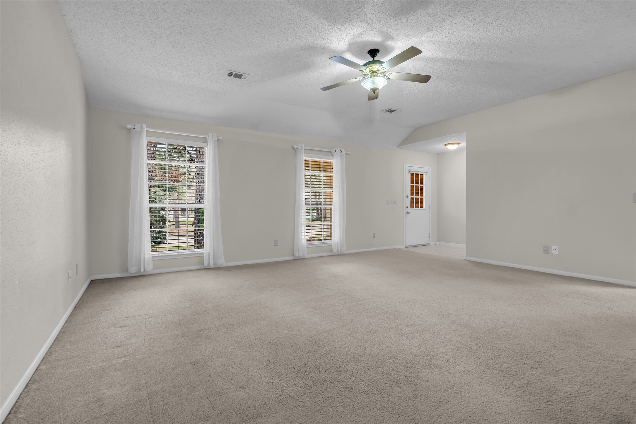 10 Treadwell Court Spring, TX 77381 - Photo 10 of 35 Living area featuring large windows at the front for plenty of natural light. Fresh paint all thru this lovely home