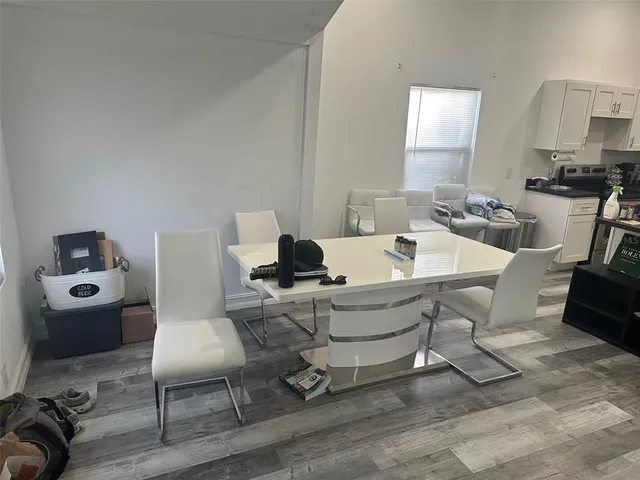 a work room with furniture a rug and white walls