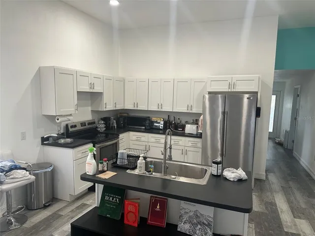 a kitchen with stainless steel appliances granite countertop a sink stove and refrigerator