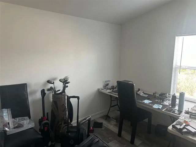 a view of a workspace with furniture and a window