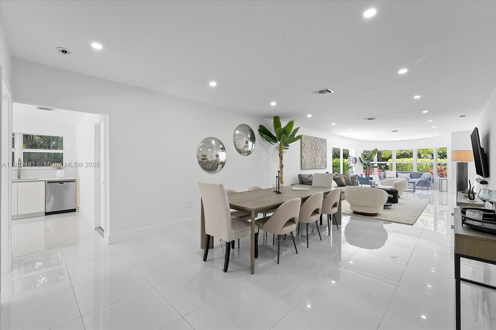 3020 Alton Road Miami Beach, FL 33140 - Photo 12 of 40 a dining room with furniture and a view of living room