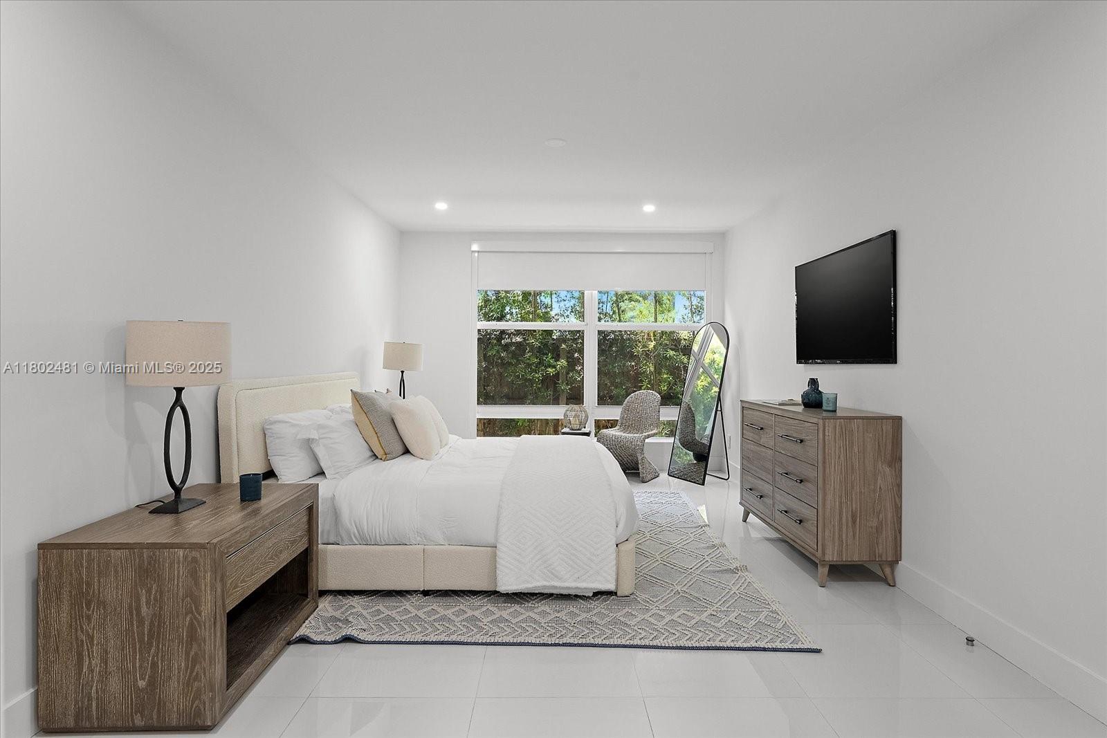 3020 Alton Road Miami Beach, FL 33140 - Photo 16 of 40 a living room with furniture and a flat screen tv