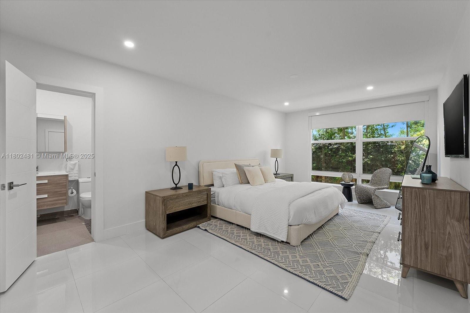 3020 Alton Road Miami Beach, FL 33140 - Photo 17 of 40 a living room with furniture and a large window