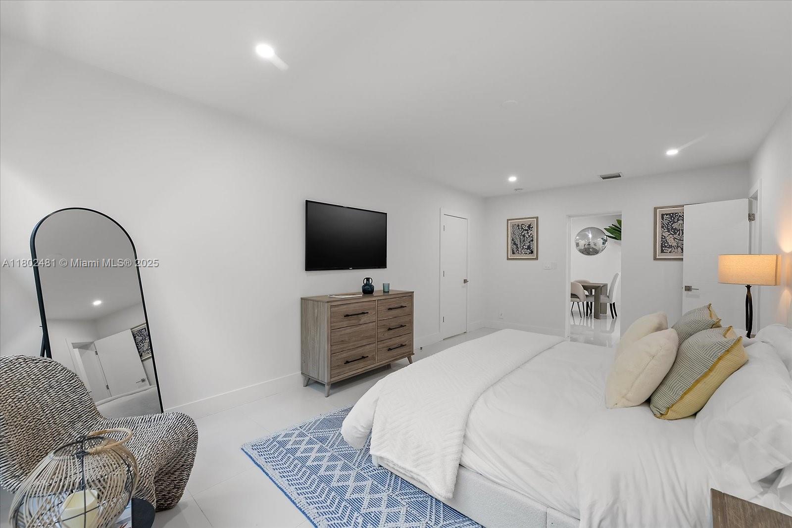 3020 Alton Road Miami Beach, FL 33140 - Photo 18 of 40 a bedroom with a bed and a flat screen television