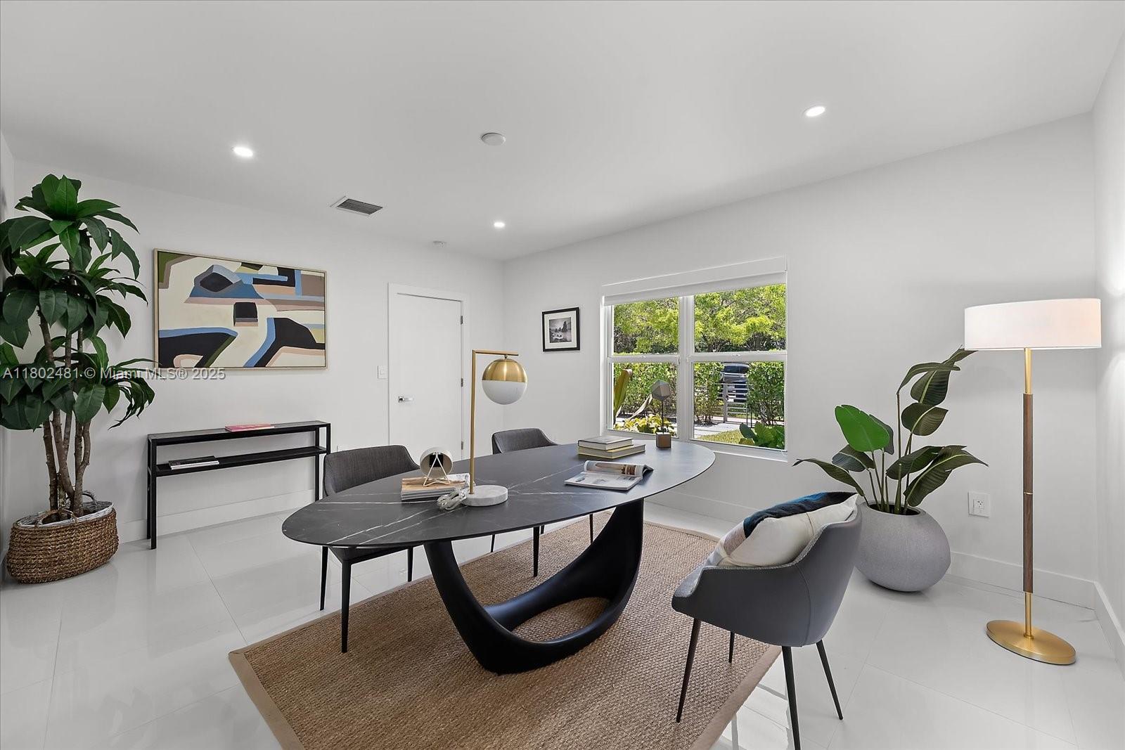 3020 Alton Road Miami Beach, FL 33140 - Photo 22 of 40 a view of a workspace with a table and a potted plant