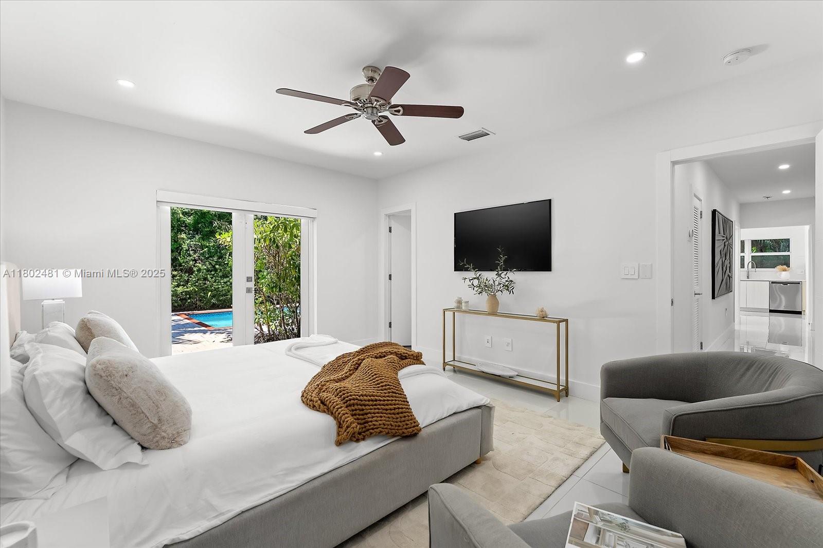 3020 Alton Road Miami Beach, FL 33140 - Photo 25 of 40 a living room with furniture and a flat screen tv