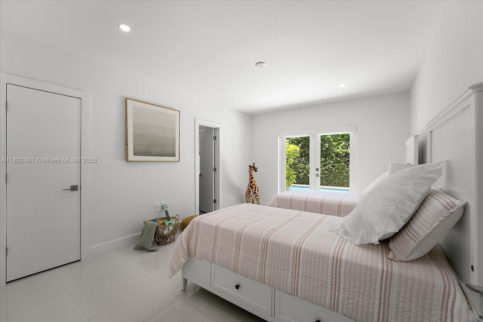 3020 Alton Road Miami Beach, FL 33140 - Photo 27 of 40 a bedroom with a bed and a window