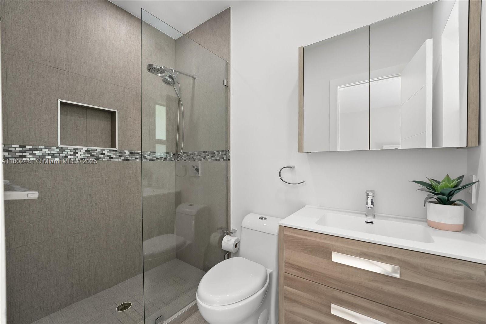 3020 Alton Road Miami Beach, FL 33140 - Photo 29 of 40 a bathroom with a sink a toilet and shower