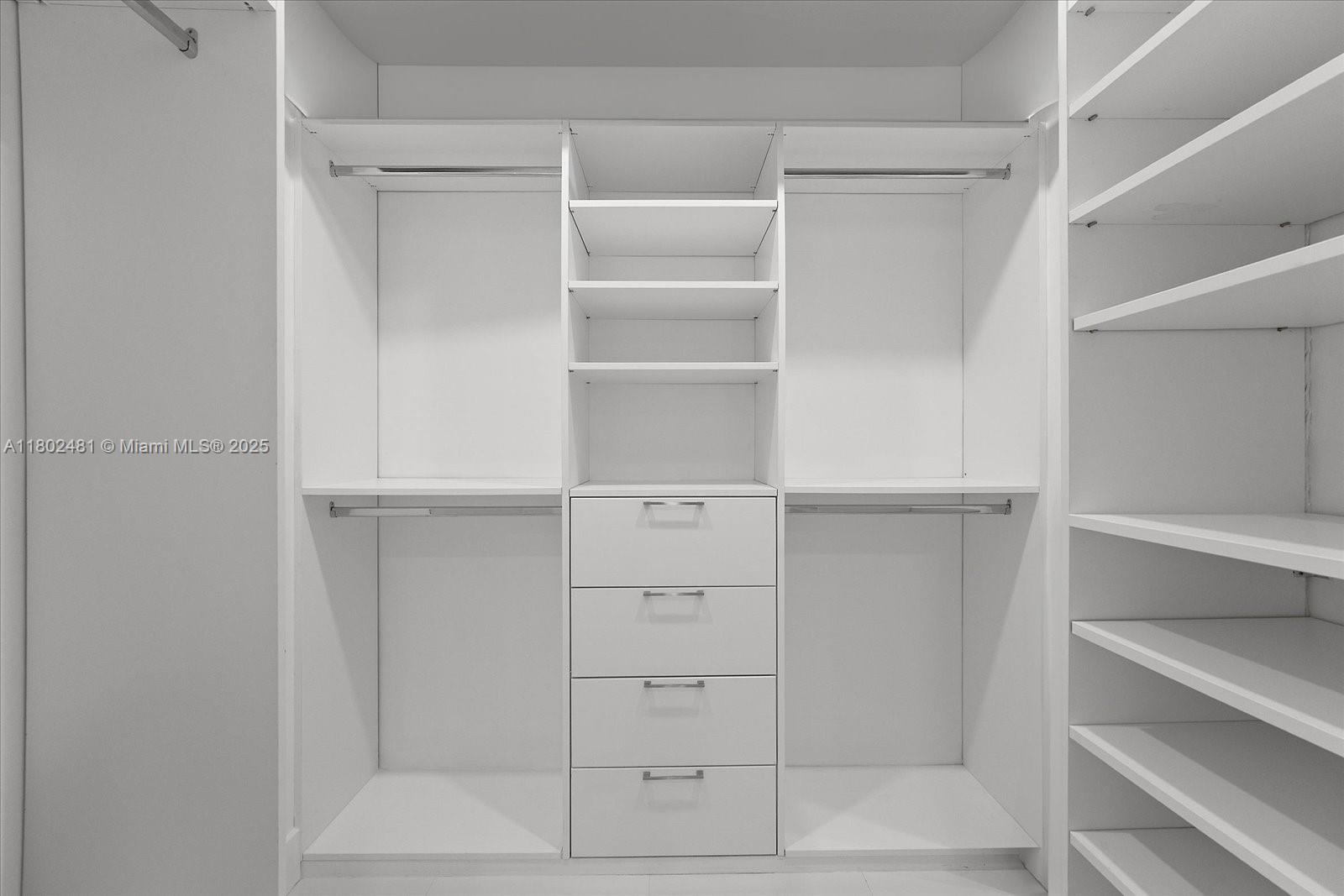 3020 Alton Road Miami Beach, FL 33140 - Photo 30 of 40 a view of walk in closet with empty racks