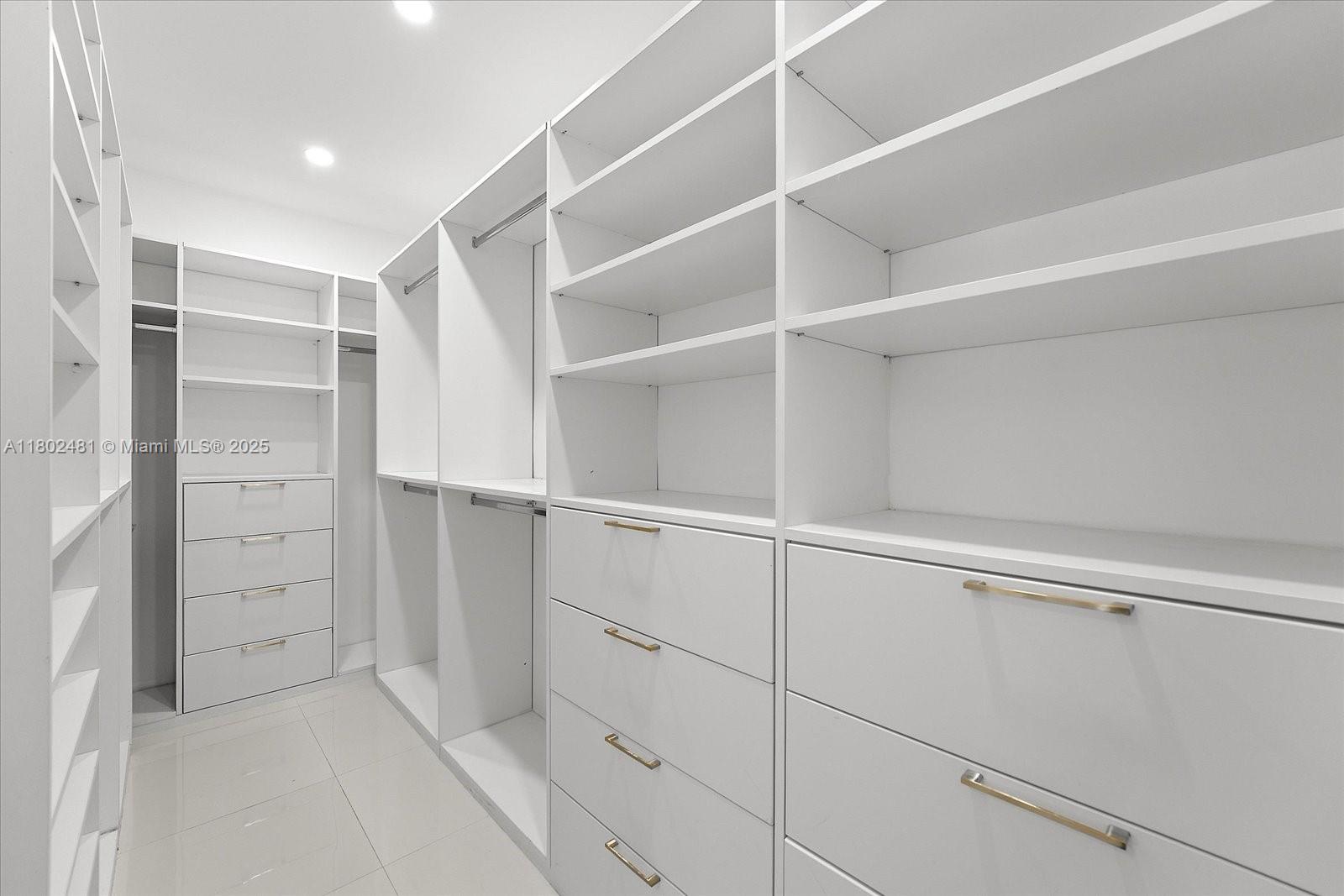 3020 Alton Road Miami Beach, FL 33140 - Photo 31 of 40 a view of walk in closet with empty racks