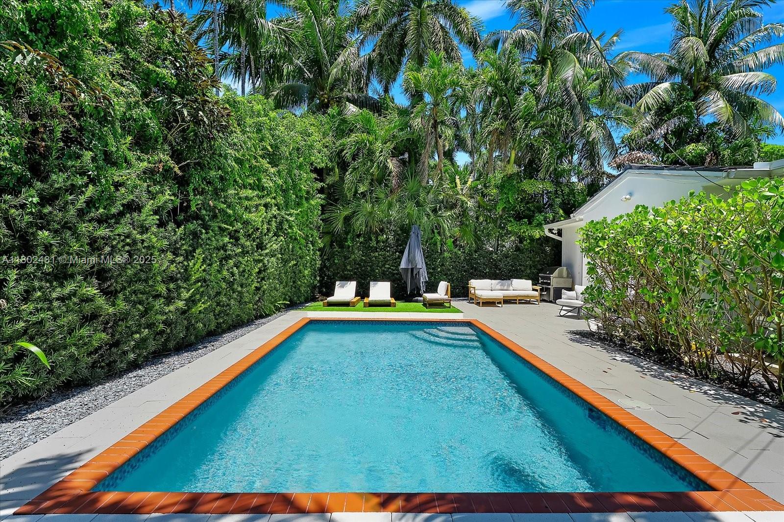 3020 Alton Road Miami Beach, FL 33140 - Photo 34 of 40 a view of a backyard with swimming pool