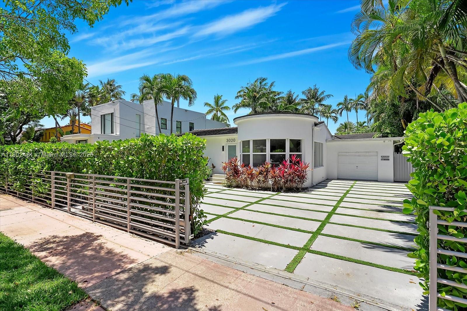 3020 Alton Road Miami Beach, FL 33140 - Photo 35 of 40 a front view of a house with a yard