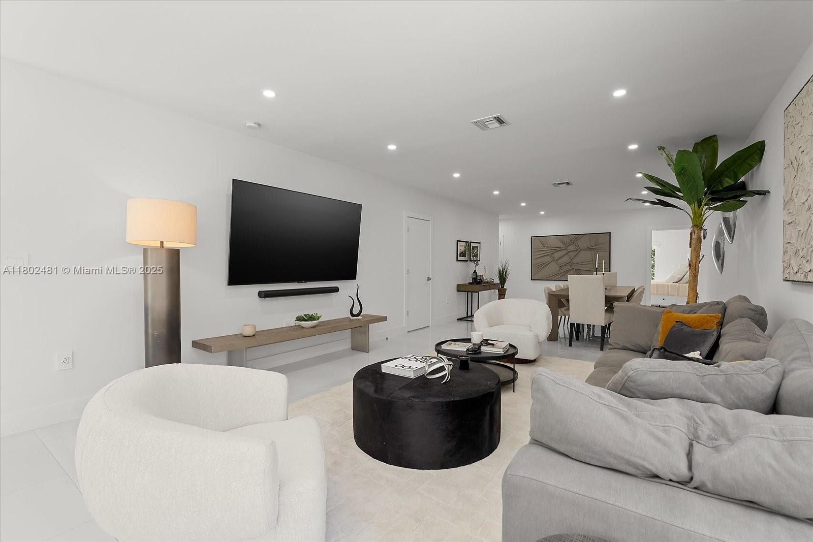 3020 Alton Road Miami Beach, FL 33140 - Photo 6 of 40 a living room with furniture and a flat screen tv