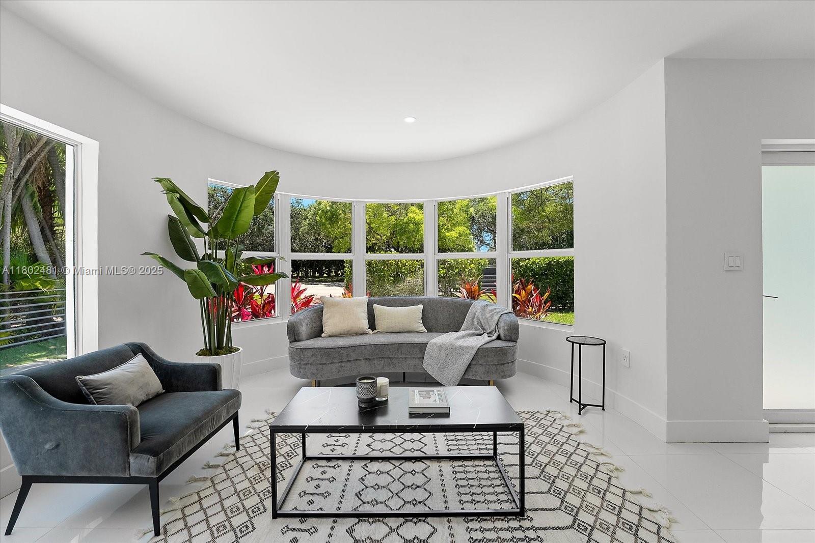 3020 Alton Road Miami Beach, FL 33140 - Photo 7 of 40 a living room with furniture and a large window