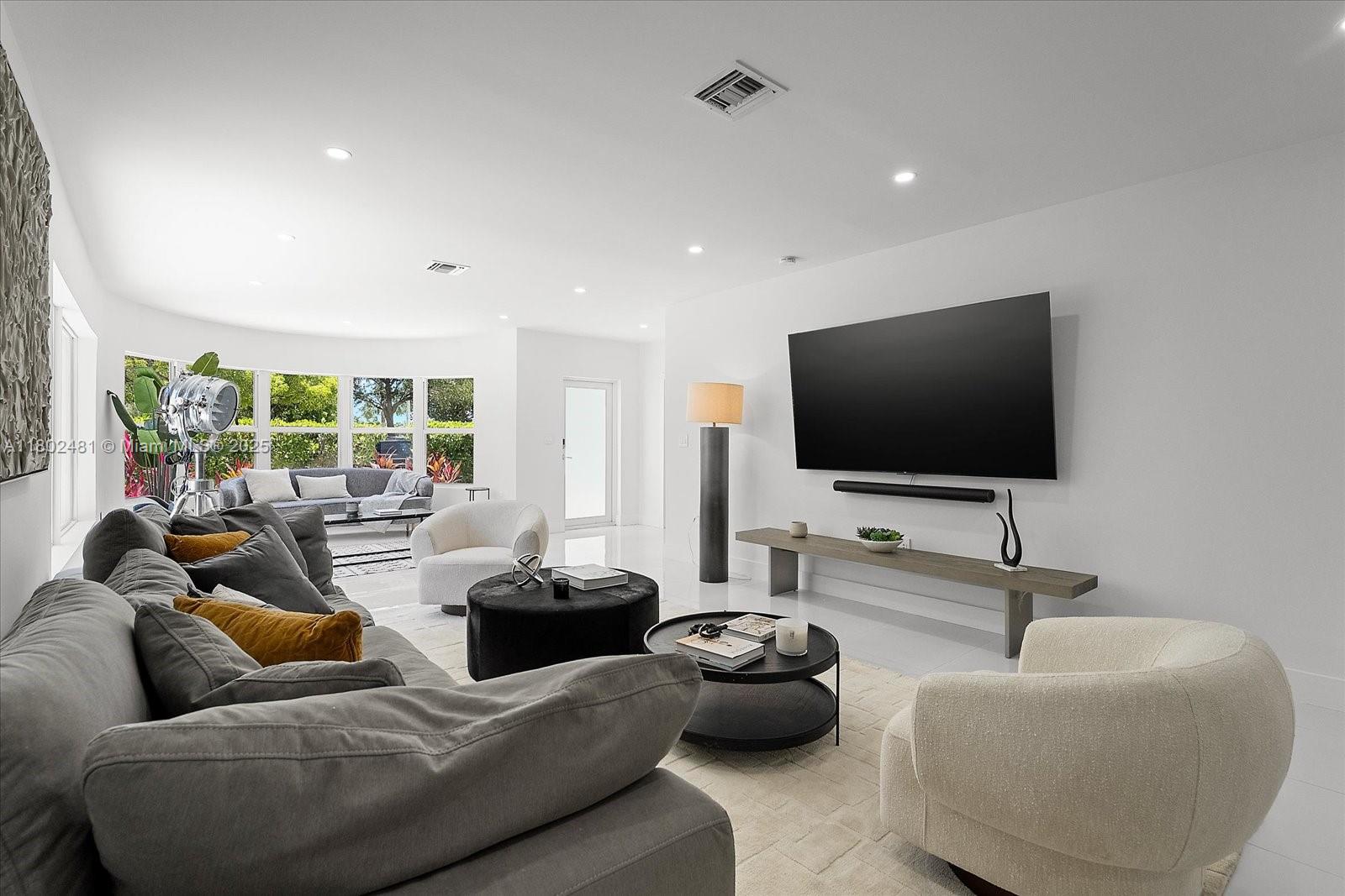 3020 Alton Road Miami Beach, FL 33140 - Photo 8 of 40 a living room with furniture and a flat screen tv
