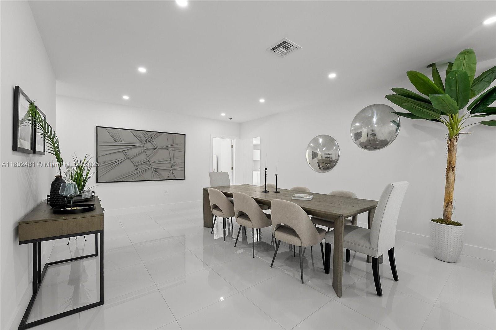 3020 Alton Road Miami Beach, FL 33140 - Photo 10 of 40 a view of a dining room with furniture and wooden floor