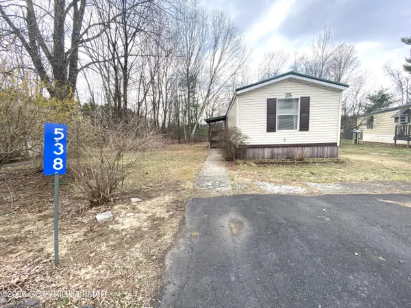a view of a house with snow on the road
