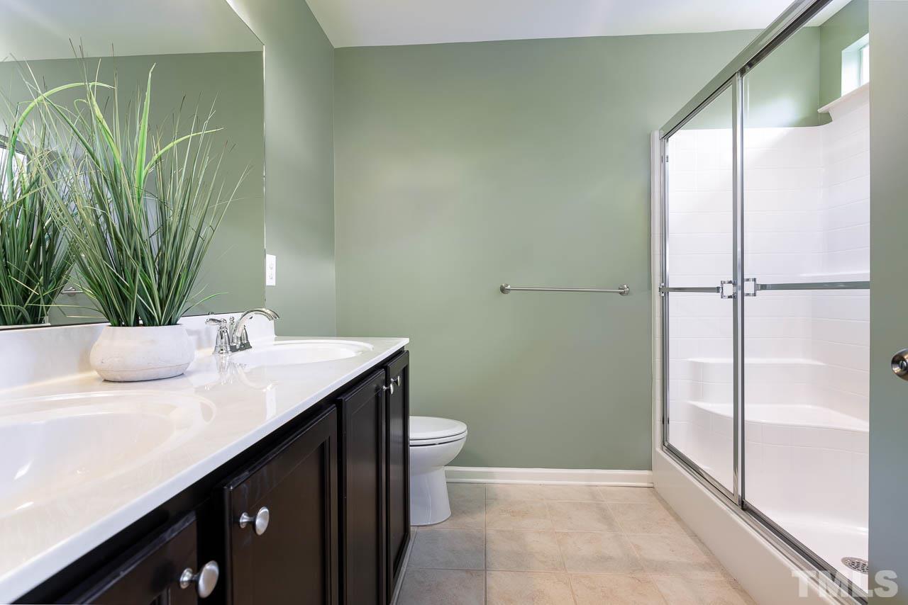 421 Provincial Street Raleigh, NC 27603 - Photo 12 of 22 a bathroom with a sink and a mirror