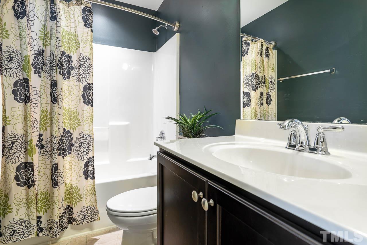 421 Provincial Street Raleigh, NC 27603 - Photo 16 of 22 a bathroom with a granite countertop sink and a mirror