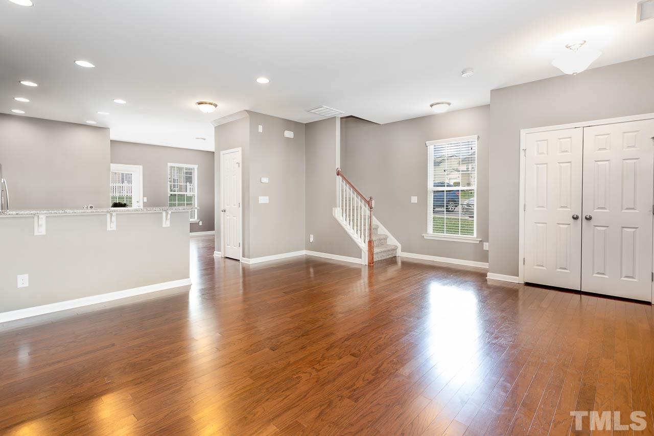 421 Provincial Street Raleigh, NC 27603 - Photo 3 of 22 a view of an empty room with wooden floor and a window