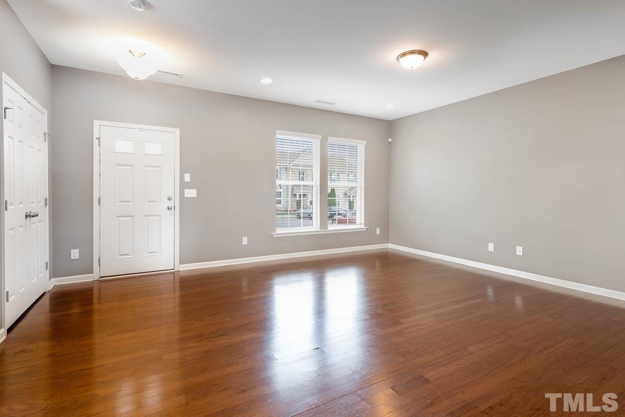 421 Provincial Street Raleigh, NC 27603 - Photo 6 of 22 a view of an empty room with wooden floor and a window