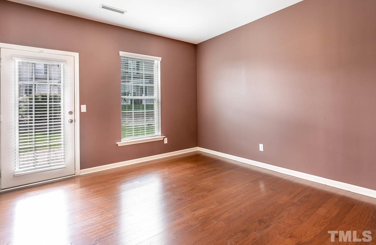 421 Provincial Street Raleigh, NC 27603 - Photo 7 of 22 a view of an empty room with wooden floor and a window