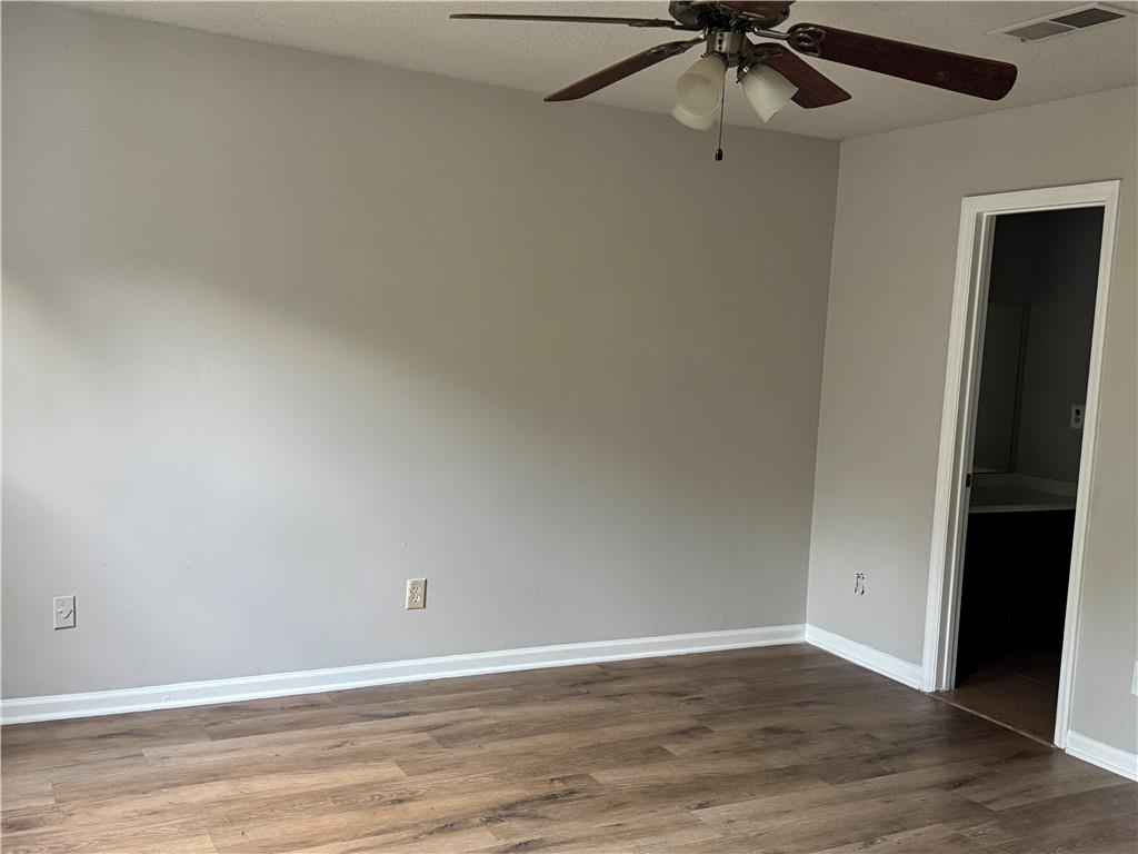 1419 Stone Mill Trace Stone Mountain, GA 30083 - Photo 3 of 7 a view of an empty room with wooden floor