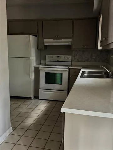 a kitchen with cabinets and stainless steel appliances