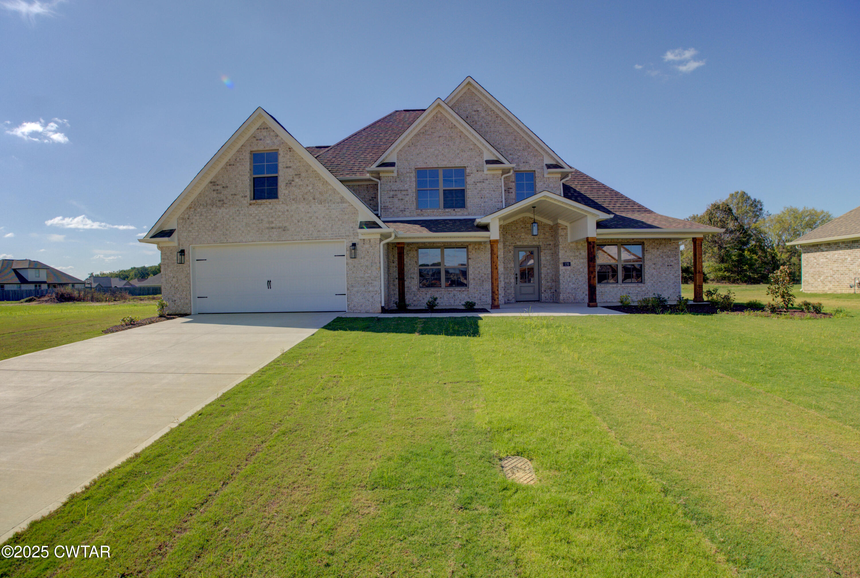 a front view of house with yard and green space