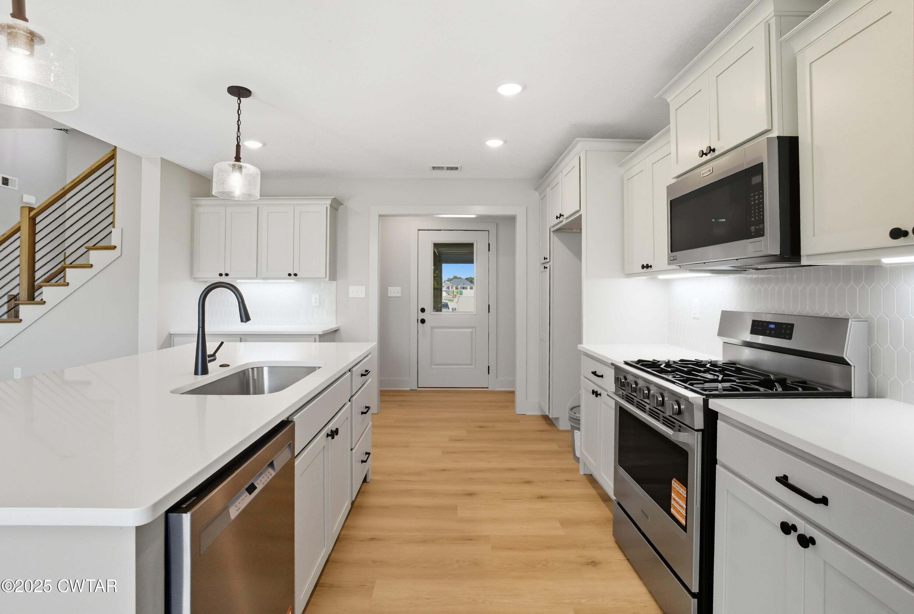 170 Daybreak Loop Medina, TN 38355 - Photo 12 of 31 a kitchen with stainless steel appliances granite countertop a sink and a stove top oven with wooden floor