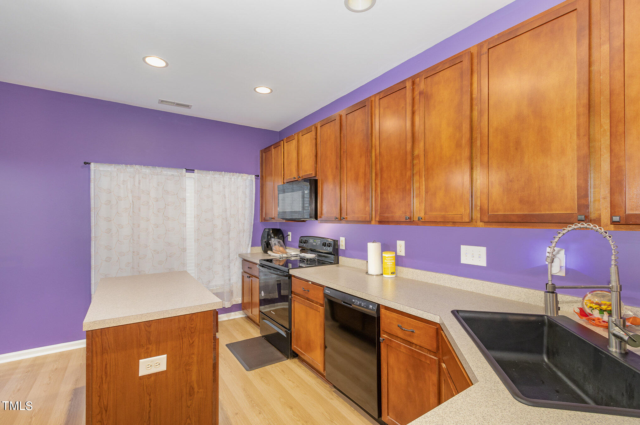 1665 Snow Mass Way Durham, NC 27713 - Photo 12 of 34 a kitchen with a sink stove and cabinets