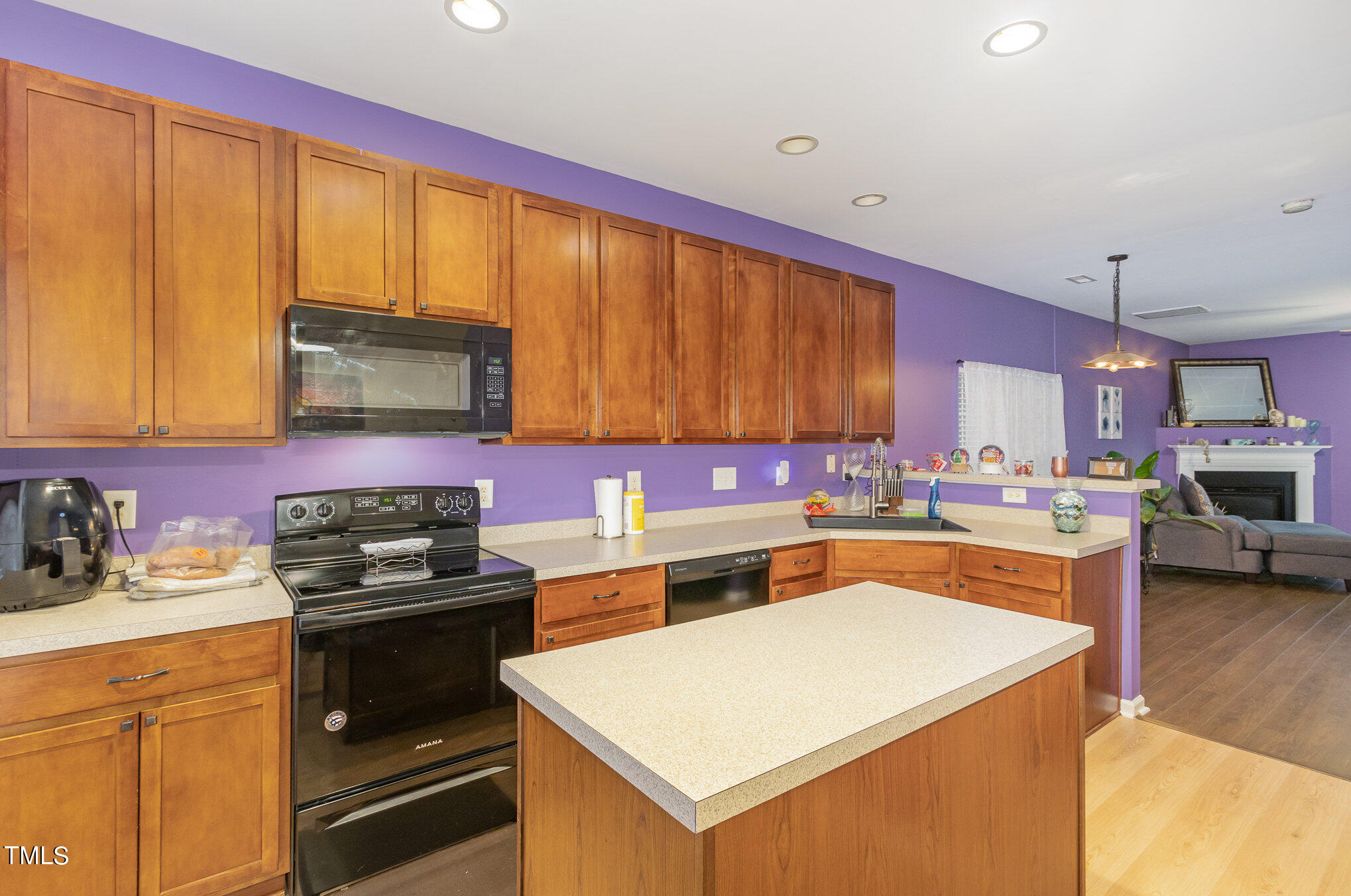 1665 Snow Mass Way Durham, NC 27713 - Photo 14 of 34 a kitchen with a stove a sink and a microwave