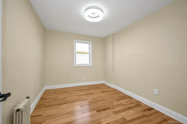 a view of a room with wooden floor and window