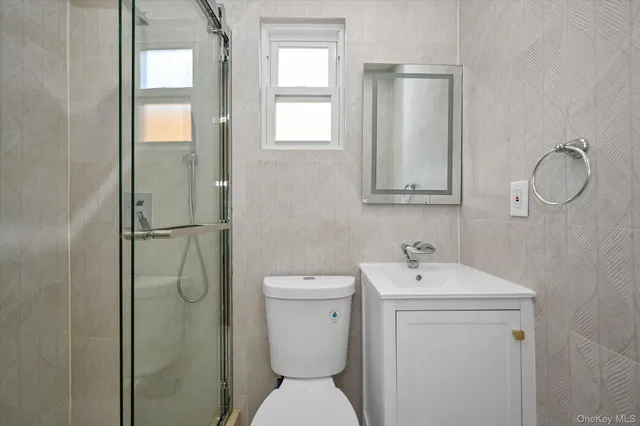 a bathroom with a toilet sink and a window