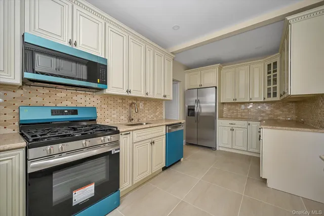 a kitchen with stainless steel appliances granite countertop a stove microwave and cabinets