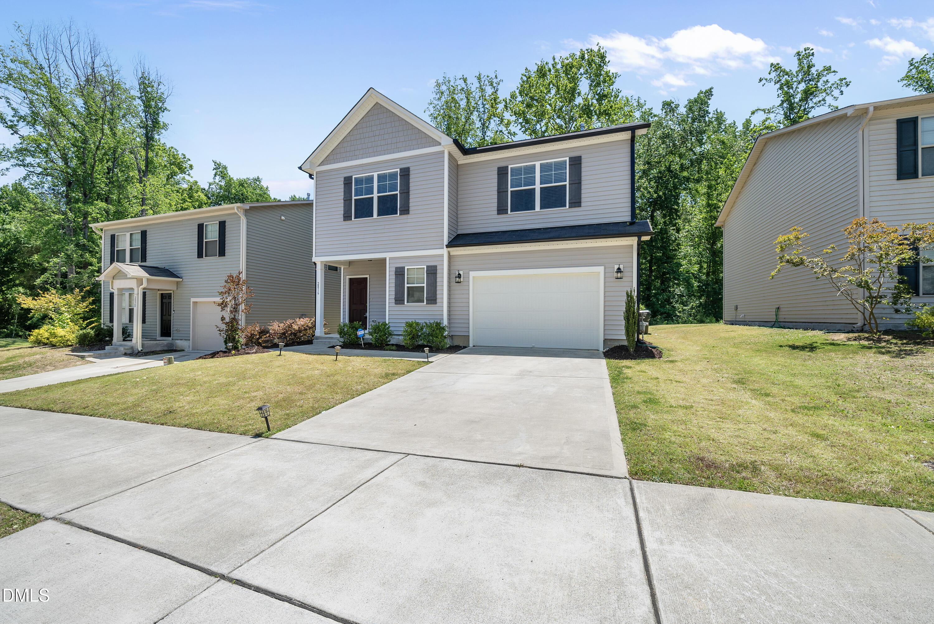 2816 Elsa Drive Raleigh, NC 27610 - Photo 4 of 35 a front view of a house with a yard and garage