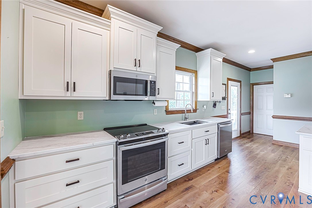 827 Sutherland Road Church Road, VA 23833 - Photo 16 of 51 Modern kitchen featuring white shaker cabinetry, s
