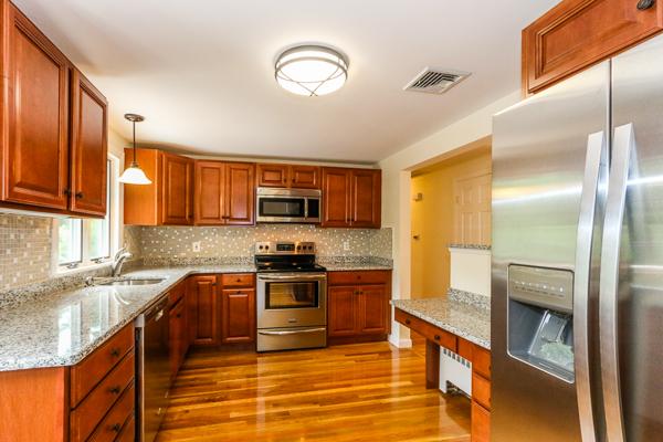 13 Scenna Road Beverly, MA 01915 - Photo 2 of 23 a large kitchen with stainless steel appliances granite countertop a stove a sink and a refrigerator