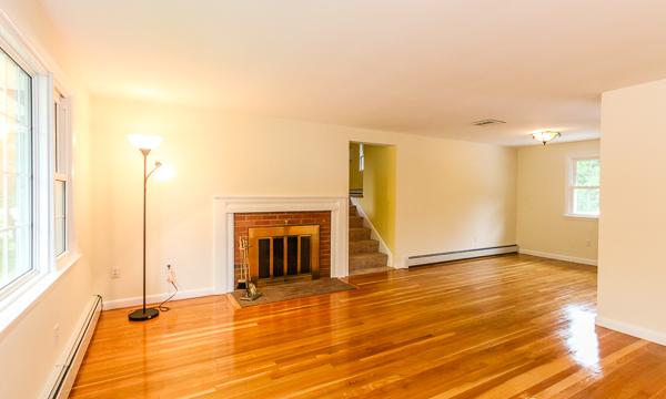 13 Scenna Road Beverly, MA 01915 - Photo 4 of 23 a view of an empty room with a fireplace and a window