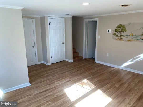 a view of a room with wooden floor and window
