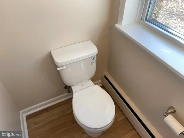 a white toilet sitting next to a window